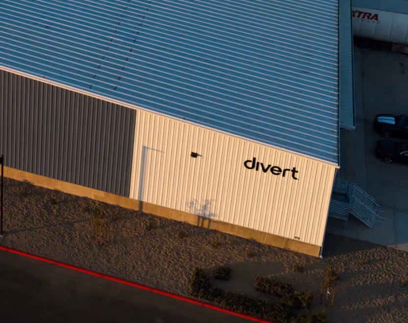 A building with a metal roof and siding that has the word 'divert' on the wall.